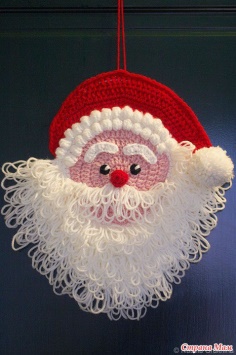 Knitted Christmas decoration on the door Santa Claus
